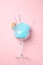 Glass with cotton candy and macaroon on pink background Royalty Free Stock Photo