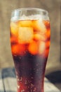 A glass covered with dew drops with a cold drink