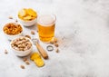 Glass of craft lager beer with snack and opener on stone kitchen Royalty Free Stock Photo