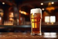 Glass of crisp cold lager beer on counter in pub for refreshing happy hour drink Royalty Free Stock Photo