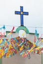 Glass cross of the exterior facade of the church with decoration of Mexican pennants