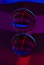 Glass crystal ball on a mirror surface with a blue and purple pattern light painting fractals Royalty Free Stock Photo