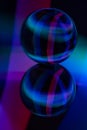 Glass crystal ball on a mirror surface with a blue and purple pattern light painting fractals Royalty Free Stock Photo