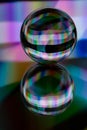 Glass crystal ball on a mirror surface with a rgb multicolor pattern light painting fractals Royalty Free Stock Photo