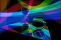 Glass crystal ball and sand clock on a mirror, with a rgb multicolor pattern light painting fractals Royalty Free Stock Photo