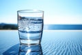 A glass of crystal clear water, set against a backdrop of serene nature Royalty Free Stock Photo