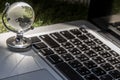 Glass crystal globe on Laptop keyboard Royalty Free Stock Photo