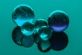 Glass, crystal marbles on blue background Royalty Free Stock Photo