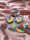 Glass cubes with rainbow reflections on satin fabric Royalty Free Stock Photo