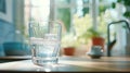 A glass cup being filled with clean water from a tap in the kitchen Royalty Free Stock Photo