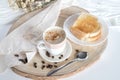 Glass cup with coffee and milk, cappuccino, served with toasted bread with butter on a light background. Royalty Free Stock Photo