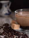 Glass cup with coffee with milk, latte coffee. A jug of milk in the background. Cane sugar on a saucer. Coffee beans on a wooden Royalty Free Stock Photo