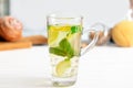 Glass cup of cold mint tea with lemon and ginger on table Royalty Free Stock Photo