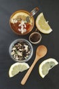 Glass Cup of Herbal Tea with Acacia Flowers and honey on Black Background, top view, Copy space. Health Drink Coldness Royalty Free Stock Photo