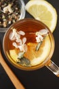 Glass Cup of Herbal Tea with Acacia Flowers and honey on Black Background, top view, Copy space. Health Drink Coldness Royalty Free Stock Photo