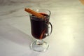 Glass cup with hot mulled wine with lemon and sticks of cinnamon and star anise. Close-up Royalty Free Stock Photo