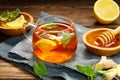 A glass cup of hot tea with lemon, mint, ginger and honey on wooden rustic table Royalty Free Stock Photo