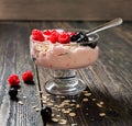Glass cup with ice cream and ripe berries on a wooden table Royalty Free Stock Photo