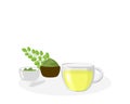 Glass cup of moringa tea with green leaf