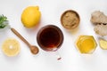 A glass cup of natural tea with ginger, lemon, mint and honey on white background. Royalty Free Stock Photo