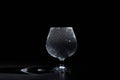 Glass cup with pure mineral water with bubbles on a black background Royalty Free Stock Photo