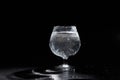 Glass cup with pure mineral water with bubbles on a black background Royalty Free Stock Photo