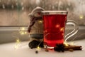 a glass cup of a red warming drink (tea, mulled wine, punch). ingredients for winter hot drinks. snowman Royalty Free Stock Photo