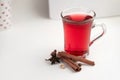 a glass cup of a red warming drink (tea, mulled wine, punch). ingredients for winter hot drinks Royalty Free Stock Photo