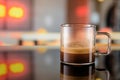 Glass cup of ristretto coffee on the bar counter with blurred background. Copy space