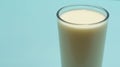 Glass cup served with milk on blue background