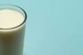 Glass cup served with milk on blue background