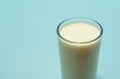 Glass cup served with milk on blue background