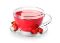 Glass cup of tasty rose hip tea and berries on white background Royalty Free Stock Photo