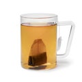 Glass cup with tea and a tea bag on white background Royalty Free Stock Photo