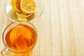 Glass cup of tea with biscuits and lemon on a light wooden background.Cup of tea with lemon and biscuits Royalty Free Stock Photo