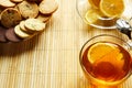 Glass cup of tea with biscuits and lemon on a light wooden background.Cup of tea with lemon and biscuits Royalty Free Stock Photo