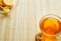 Glass cup of tea with biscuits and lemon on a light wooden background.Cup of tea with lemon and biscuits Royalty Free Stock Photo