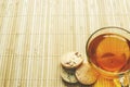 Glass cup of tea with biscuits and lemon on a light wooden background.Cup of tea with lemon and biscuits Royalty Free Stock Photo