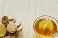 Glass cup of tea with biscuits and lemon on a light wooden background.Cup of tea with lemon and biscuits Royalty Free Stock Photo