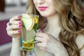 Glass cup of tea female hands. Tea with mint and citrus. Concept of lifestyle, drinks and healthy eating Royalty Free Stock Photo