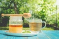 glass cup of tea with a honey can on a blue wooden table in a summer garden Royalty Free Stock Photo