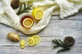 Glass cup of tea with lemon and ginger root slices, mint leaf on glass saucer on a rustic wooden table on background of Royalty Free Stock Photo