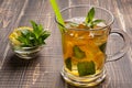 In a glass cup tea with lemon, iced and mint, cold drink Royalty Free Stock Photo