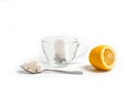 Glass cup for tea with a spoon, tea bag and lemon on a white background Royalty Free Stock Photo