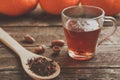 glass cup with tea and wooden spoonful of berry herbal tea Royalty Free Stock Photo