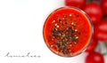 Glass cup with tomato juice with ground black pepper and cherry tomatoes on white background. top view Royalty Free Stock Photo