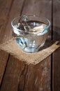 Glass cup with water on a background of burlap