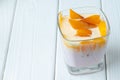 Glass cup with youghurt and fruit slices