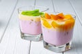 Glass cup with youghurt and fruit slices