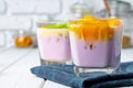 Glass cup with youghurt and fruit slices Royalty Free Stock Photo